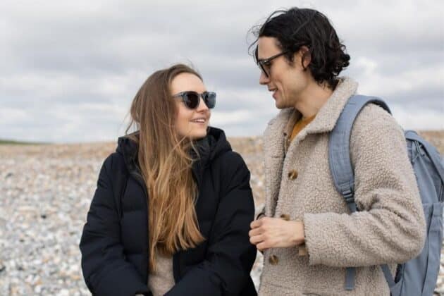 man and woman wearing sustainable sunglasses talking about climate change