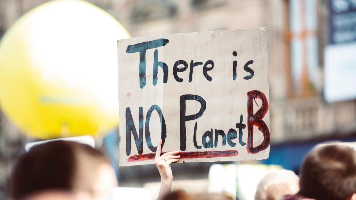 protester holding up a no planet b sign