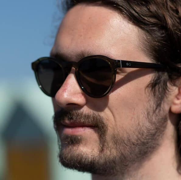 Man wearing Lich Forest Man wearing round green sustainable sunglasses