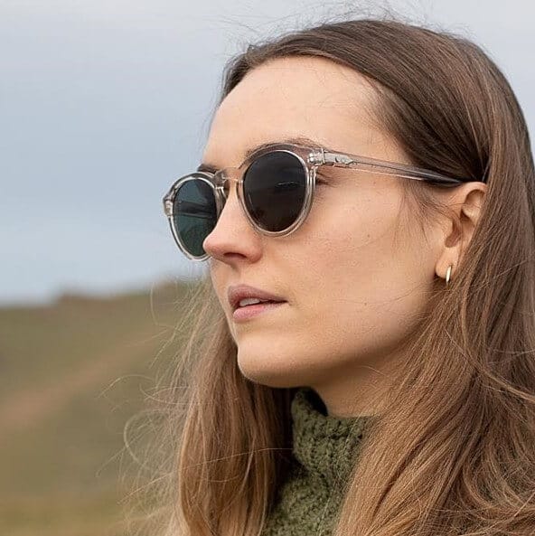 woman wearing round grey sustainable sunglasses