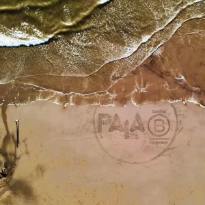 Pala B Corp logo written in the sand