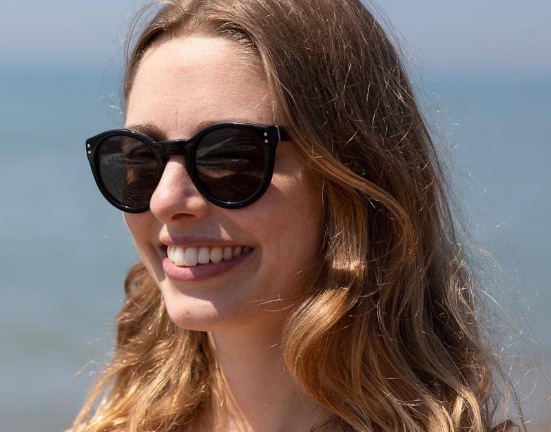 woman wearing round black ethical sunglasses