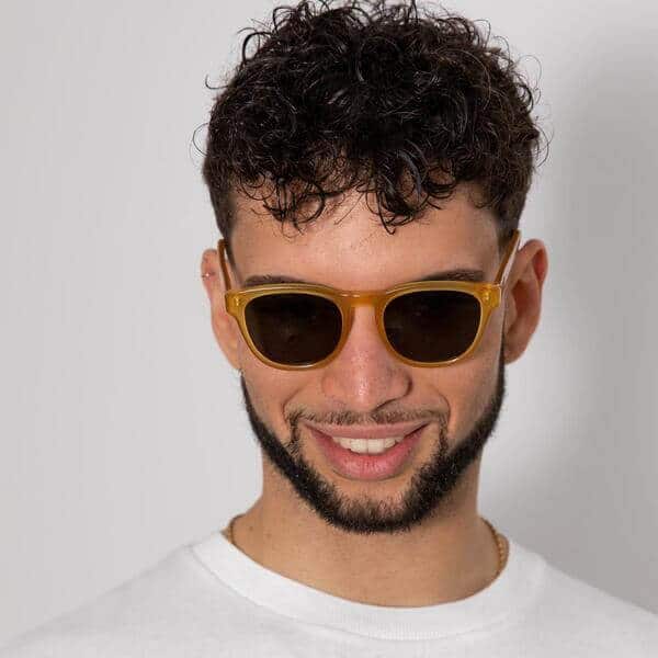 man wearing orange square sunglasses with eco friendly lenses