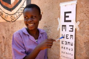 Girl giving eye examination in zambia africa with pala
