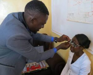 Optometrist giving eye test in Africa