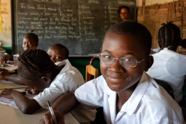 Boy wearing spectacles in classroom