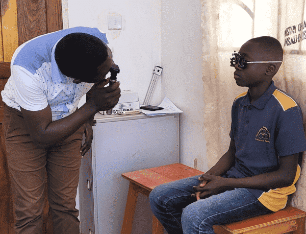 testing eyesight of young African boy in Zambia