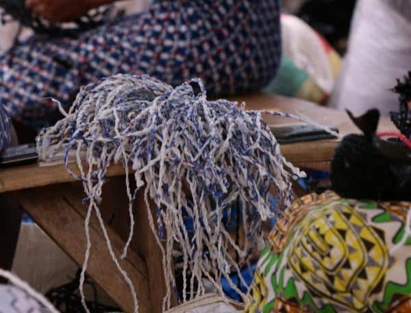 Pile of recycled plastic water sachets twisted into yarn to weave into Pala sunglasses cases in Ghana