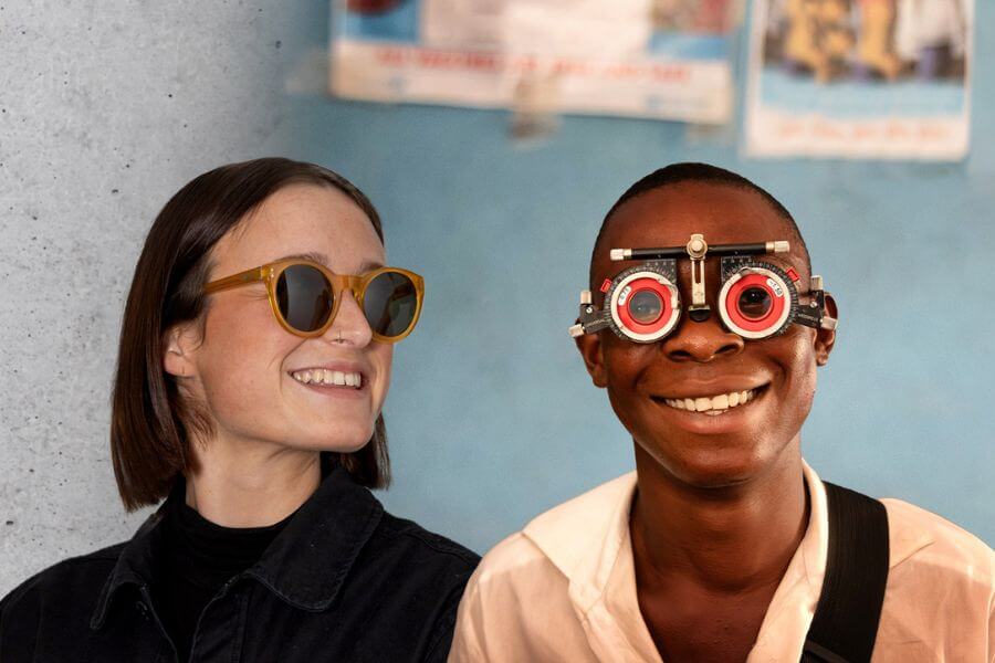 woman wearing ethical Pala sunglasses and boy wearing optical frames for eye test