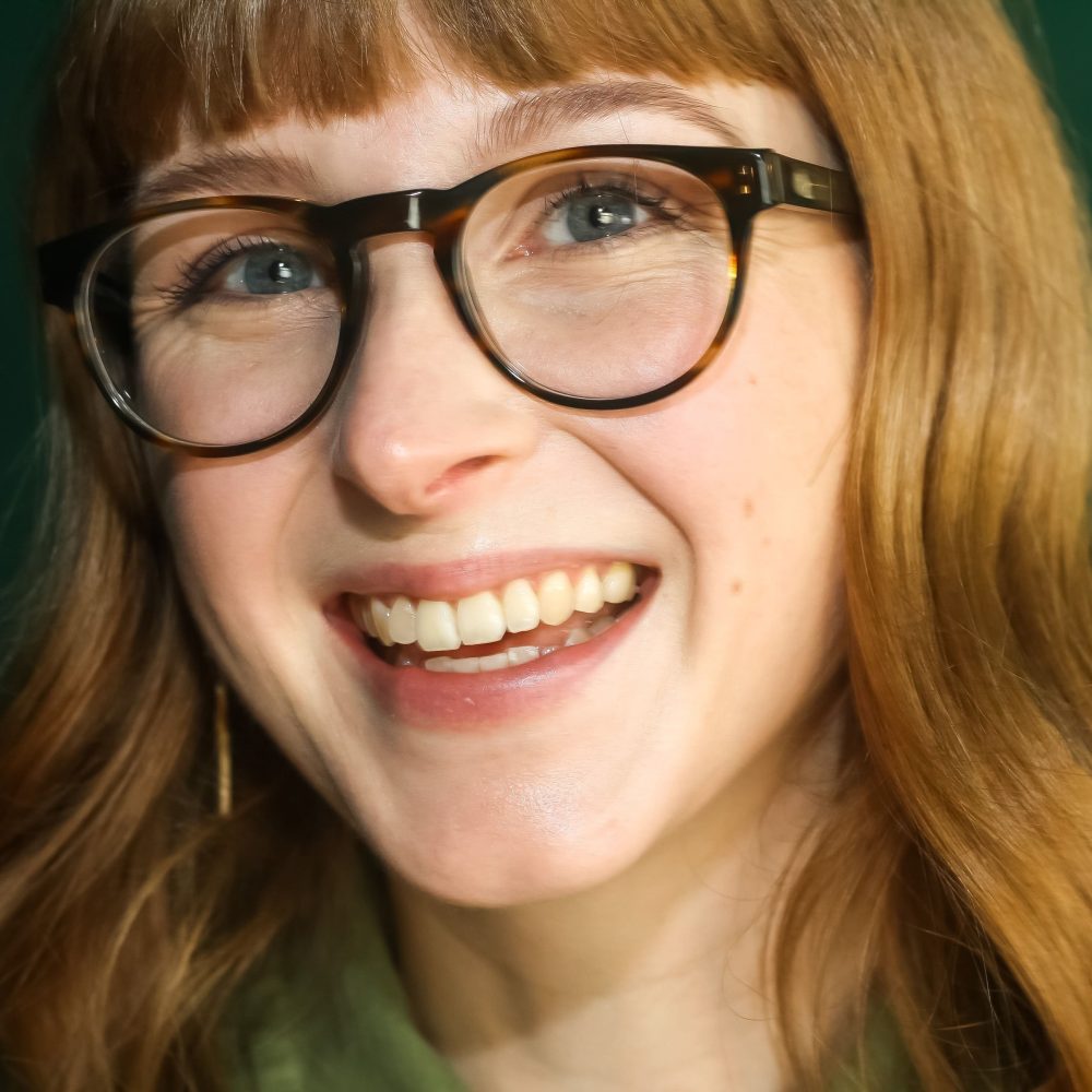 Woman wearing sustainable round prescription glasses in a brown and blue tortoiseshell colour.