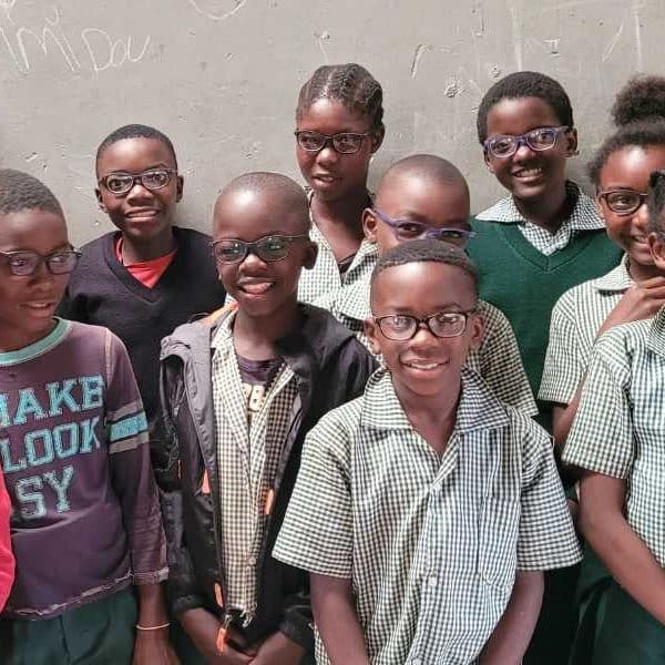 School children in Zambia receiving vision correcting glasses for the first time
