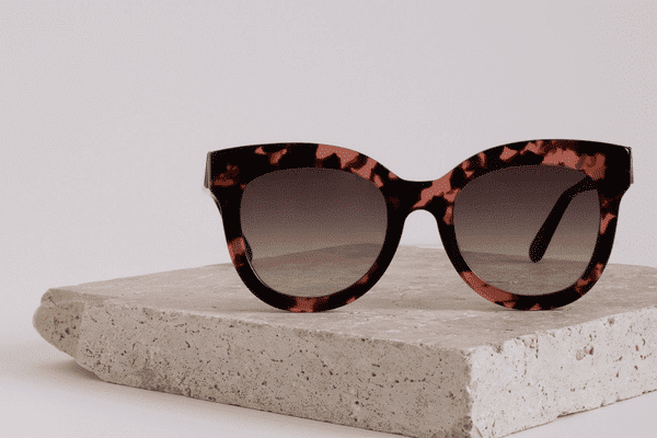 Pink and black tortoiseshell sunglasses in glamourous oversized sustainable style.