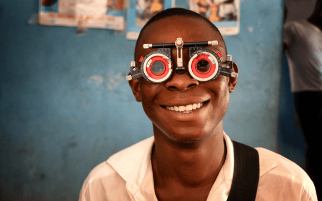 Teenage boy receiving eye test in africa