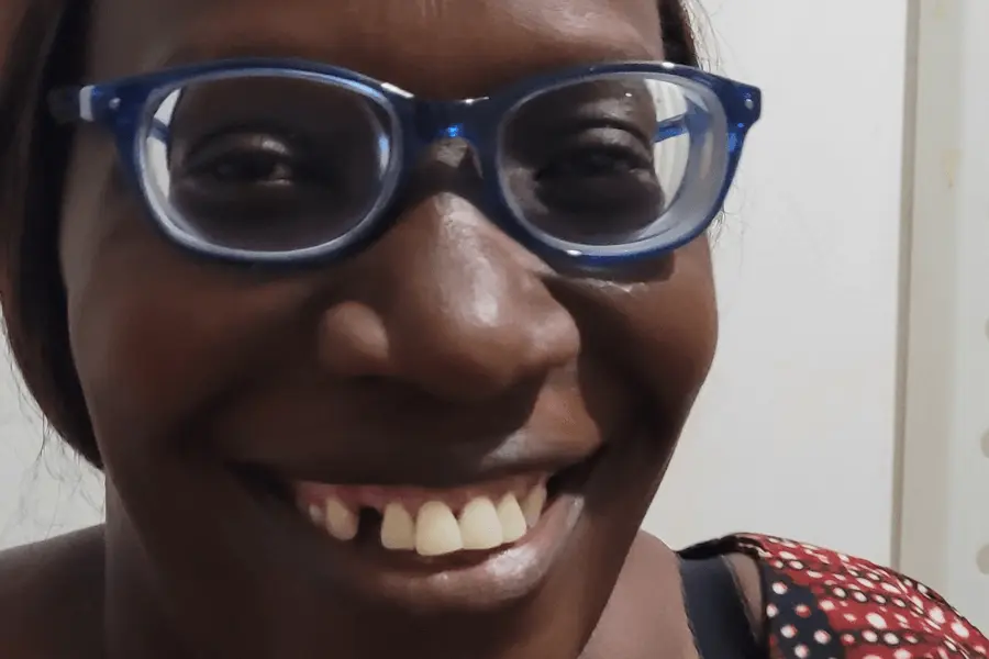 Zambian female teacher Ms Konkola smiling now wearing new prescription glasses dispensed at Chinsali Vision Centre