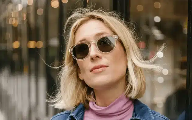Blonde woman wearing clear round sunglasses made from eco-friendly materials in camden.