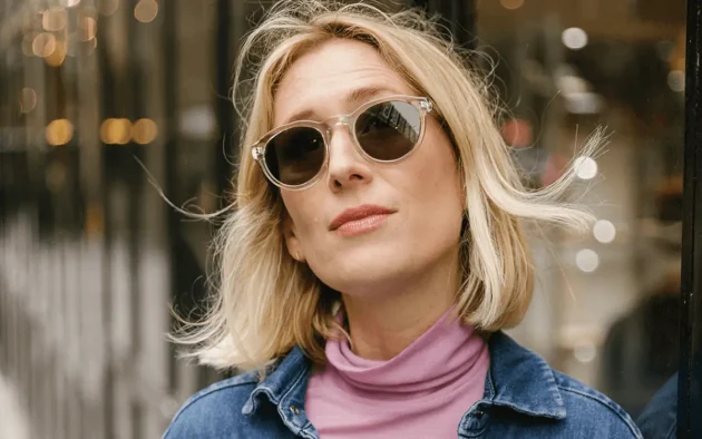 woman wearing eco-friendly sunglasses in a clear round modern design.